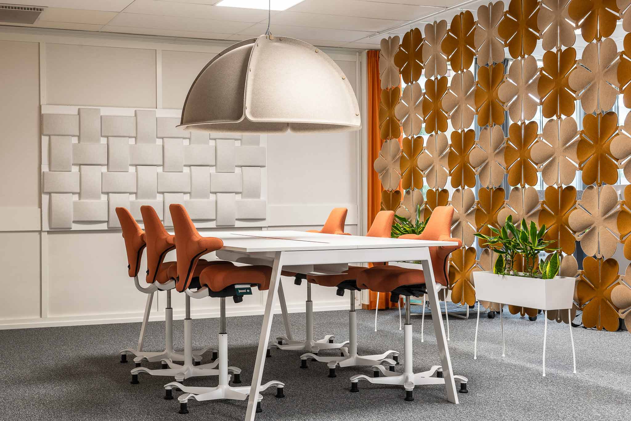 Orange HÅG Capisco chairs in Skandia office with Offecct acoustic solution